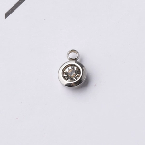 Close-up of a 6.5mm silver stainless steel pendant with a clear birthstone and jump ring