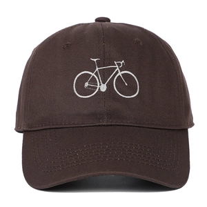 Detailed close-up of dark brown baseball cap with white embroidered bicycle pattern