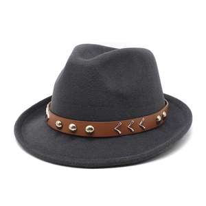 Dark grey wool fedora hat with brown leather band and silver punk rivets on white background