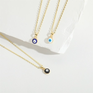 Golden Evil Eye pendant necklaces in blue, light blue, and black enamel on white stone