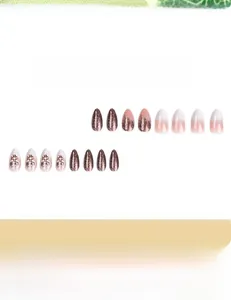 Detailed view of almond-shaped Christmas gradient nails with floral and pearl accents