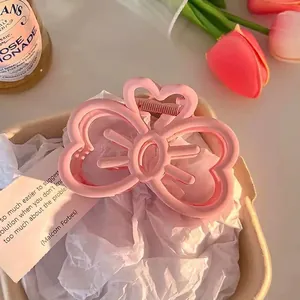 Pink ribbon bow hair claw clip with matte texture and 9cm size detail for elegant styling