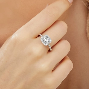 Macro view of a silver square zircon halo engagement ring featuring micro-pave diamond band