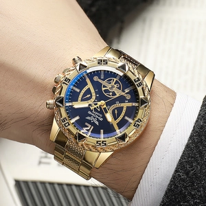 Men's luxury gold steel watch with blue dial and rugged bezel on a formal suit wrist