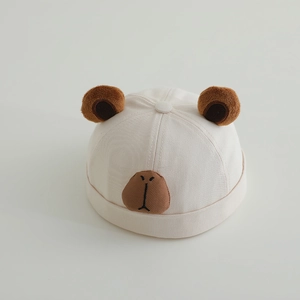 Detail of baby beige cotton beanie with cute capybara embroidery and plush ears