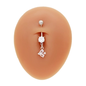 Gros plan d'un piercing de nombril cœur et flèche avec cristaux sur un mannequin