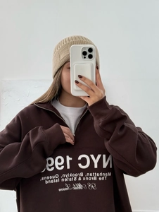 Brown half-zip sweatshirt with NYC 1999 print and ribbed knit beanie in mirror selfie