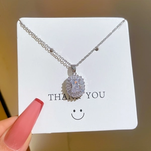 Titanium steel geometric pendant necklace with sparkling cubic zirconia on a white card