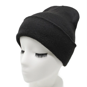 Detailed view of the thick knit texture and wide cuffed brim on a black winter beanie