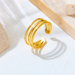 Macro detail of triple-layer gold plated stainless steel open ring on stone pedestal