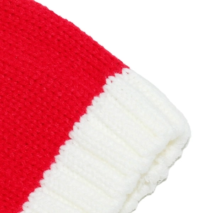 Detailed close-up of festive red knit Santa hat with thick yarn texture and white ribbed cuff