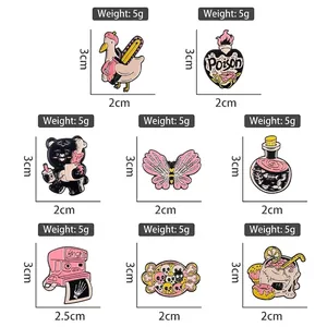 Set of creative pink enamel pins featuring camera, butterfly skull and astronaut designs