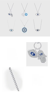 Macro detail of S925 sterling silver evil eye and hamsa pendants with pave setting cubic zirconia