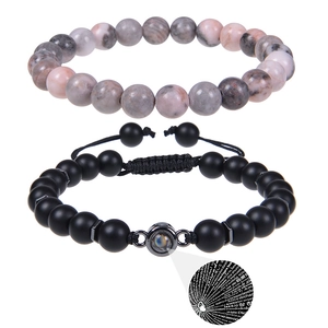 Detail of beaded couples bracelet set with micro-engraved I Love You projection stone