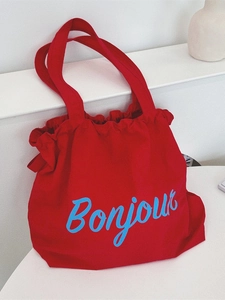 Red canvas drawstring tote bag with blue Bonjour print for casual fashion and daily use