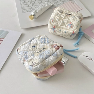 Detailed macro view of quilted sanitary napkin bags with cute cartoon animal patterns