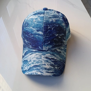 Top view of baseball cap featuring blue and white ocean wave patterns on canvas fabric