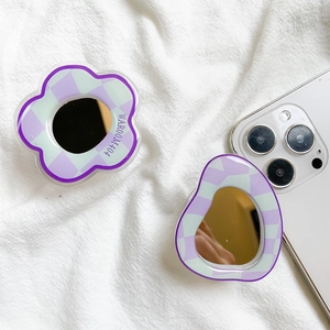 Detail of flower-shaped checkered phone grip with integrated mirror and purple frame