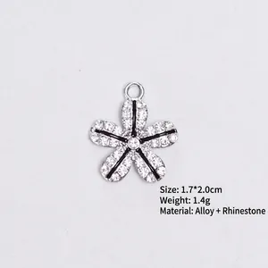 Detail showing silver alloy flower charm with black enamel and rhinestones, 1.7x2.0cm size
