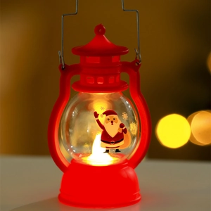 Close-up of red Christmas LED lantern with Santa Claus pattern and warm bokeh lights