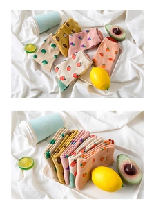 Detail of cotton crew socks with fruit patterns including strawberry and orange designs