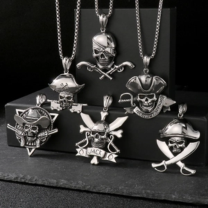 Detailed view of six vintage silver stainless steel pirate skull and weapon pendants