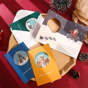 Assorted creative Christmas greeting cards with envelopes on a festive red background