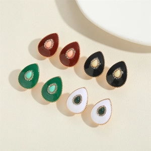 Close-up of teardrop earrings in burgundy, black, green and white with crystal accents