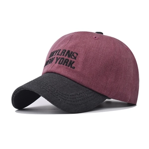 Detail of embroidered BKYLRNS NEW YORK letters on a burgundy washed cotton baseball cap