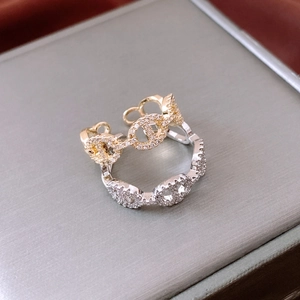 Detail of 14K gold and silver plated rings featuring pavé zircons in pig nose design