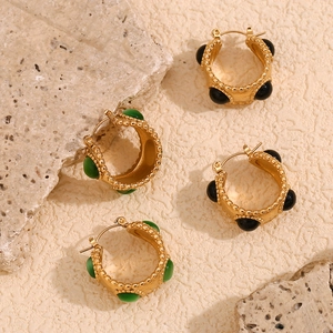 Detail of 18K gold plated beaded round earrings with green and black natural stones