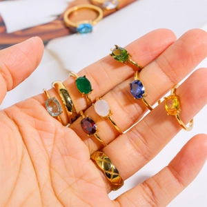 Macro shot of gold stainless steel rings with colorful birthstones and diamond patterns