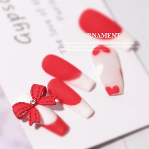 3D red bow nail charm with stitching texture and rhinestone on heart pattern nails