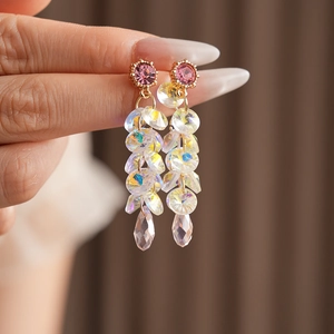 Detail of tassel earrings with pink gems and iridescent teardrop crystal beads
