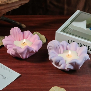 Macro view of flower shaped silicone candle holders in light pink and purple hues