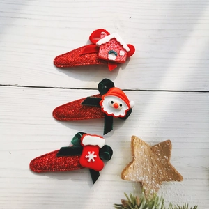 Christmas hair clips set for girls with Santa Claus and stocking on white wood