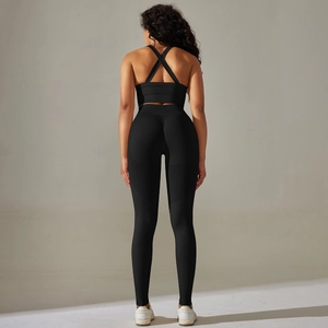 Back view of seamless black yoga set featuring criss-cross sports bra and high waist leggings