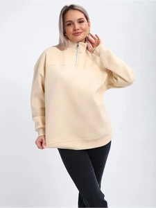 Detail of silver half-zipper on cream pullover sweatshirt with ribbed collar and cuffs