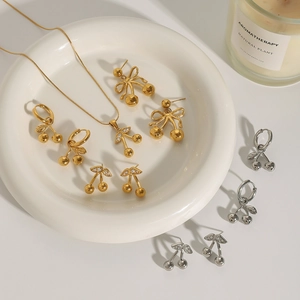 Elegant gold and silver cherry necklace and earrings set with rhinestones on ceramic