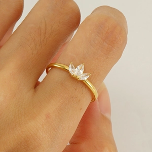 Gold plated maple leaf ring with white zircon stones shown on a model hand