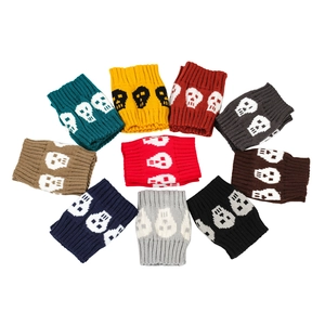 Close-up of knitted skull leg warmers in various colors including red and blue