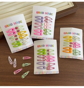 Close-up of colorful mini fruit pattern BB hair clips for girls on display cards