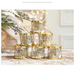 Macro shot of gold-rimmed transparent Christmas drums with snowflake filler