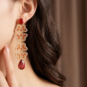 Vintage gold butterfly tassel earrings with red gemstones and sparkling zircons