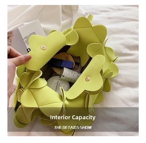 Detail view of the spacious inner compartment of the light green petal handbag