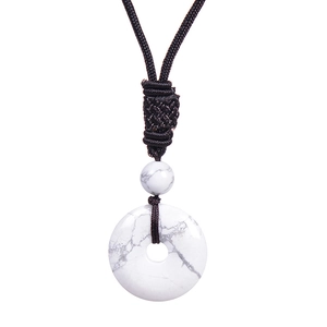 Macro detail of white turquoise donut pendant with black handmade braided cord necklace