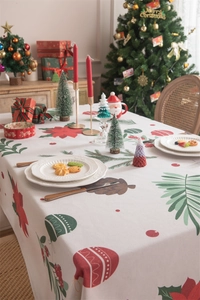 Detailed view of Christmas tablecloth with red baubles, poinsettia patterns and tassels