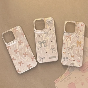 Three iPhone cases with marble texture and colorful bowknot patterns on beige background