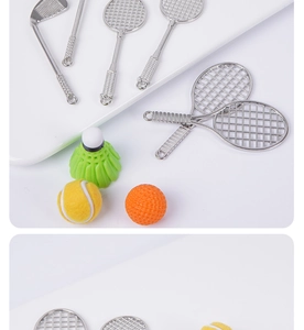 Detailed macro view of miniature metal tennis racket and golf club sports keychains