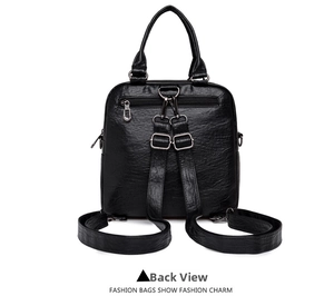 Detail view of the black leather backpack's back showing anti-theft zipper and straps